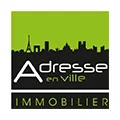 Logo "Adresse en Ville Immobilier" avec skyline.